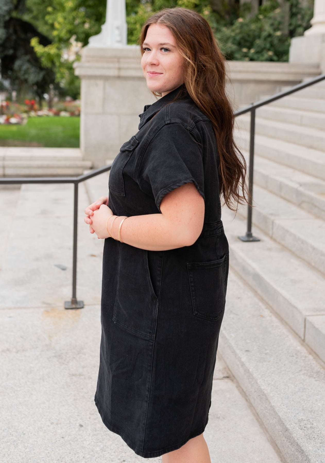 Side view of the black denim zipper dress in plus size