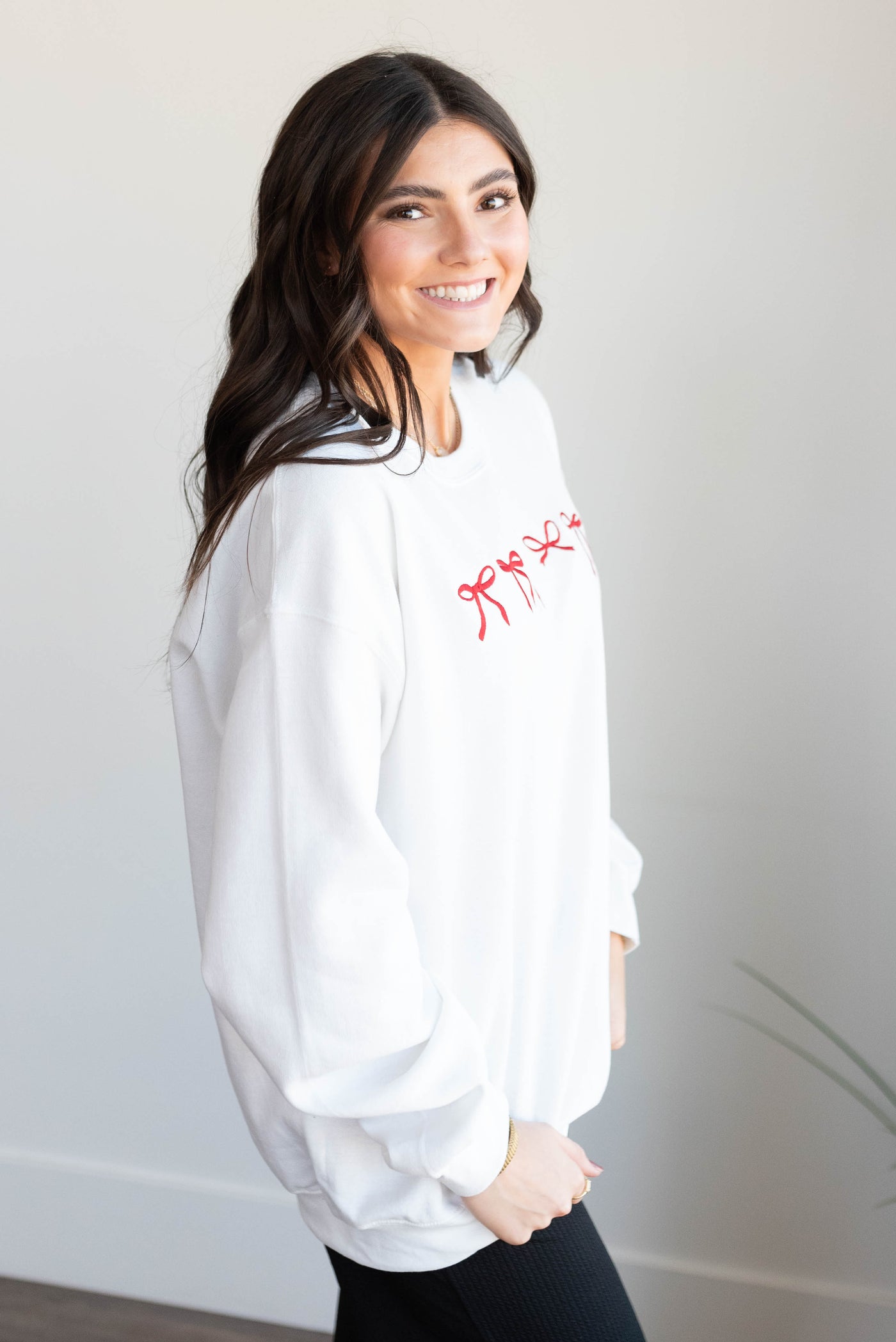 Side view of the white mini bow sweatshirt