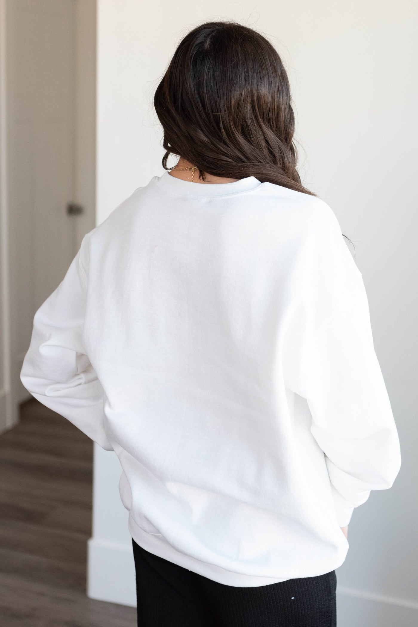 Back view of the white mini bow sweatshirt