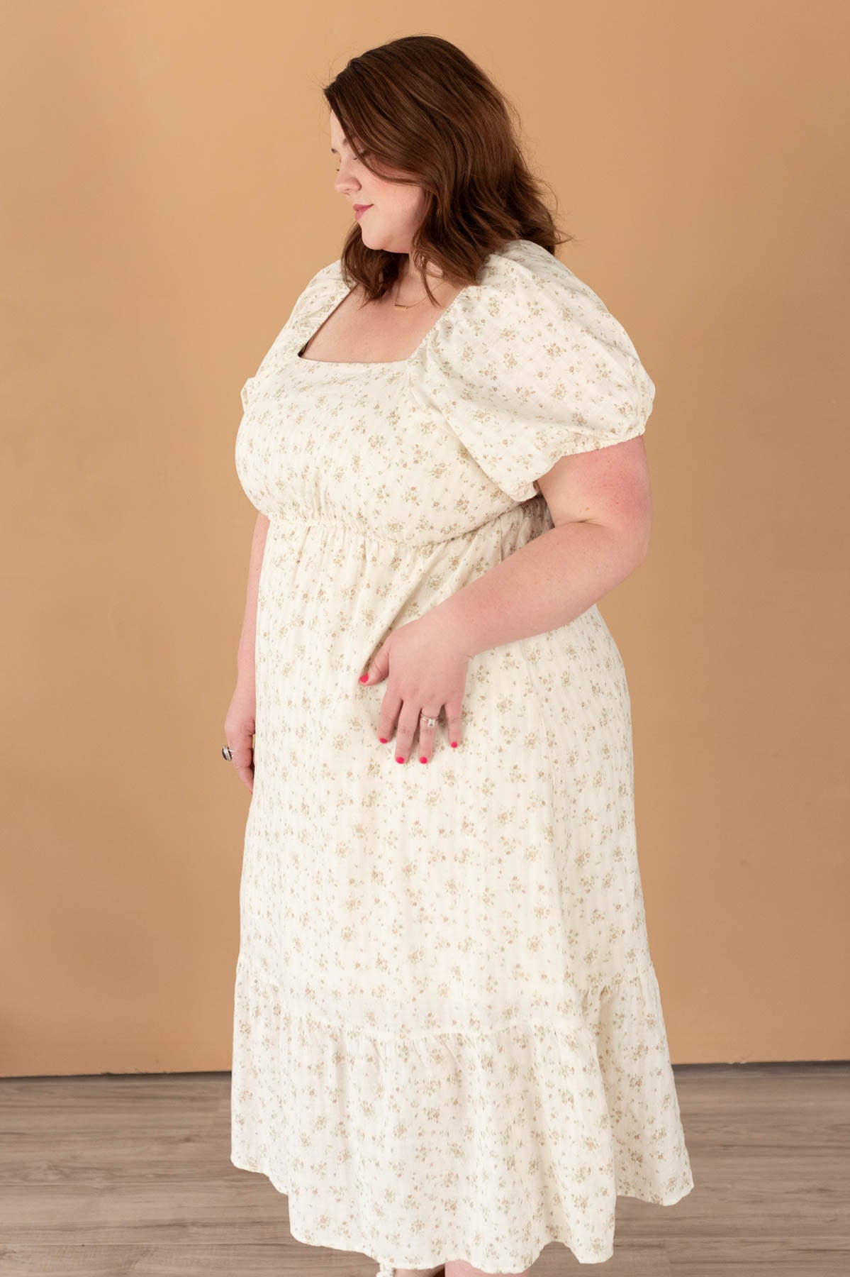 Side view of the tan floral lace dress in plus size