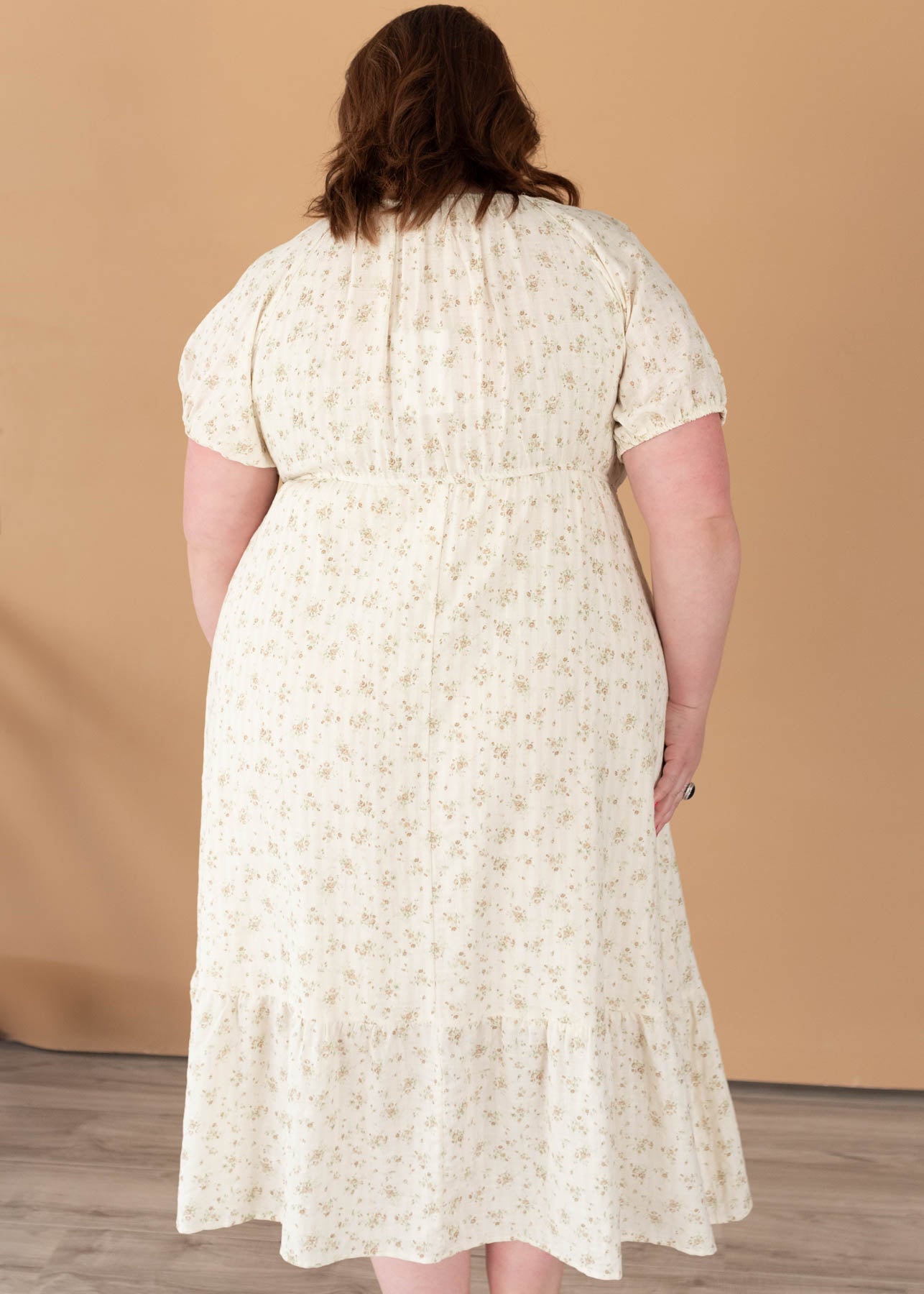 Back view of the plus size tan floral dress