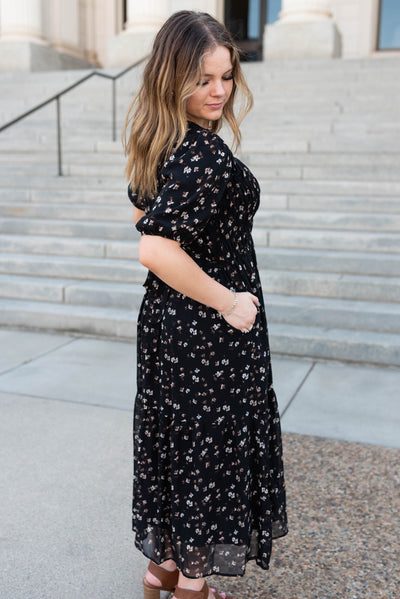 Side view of the black floral smocked dress with pocket